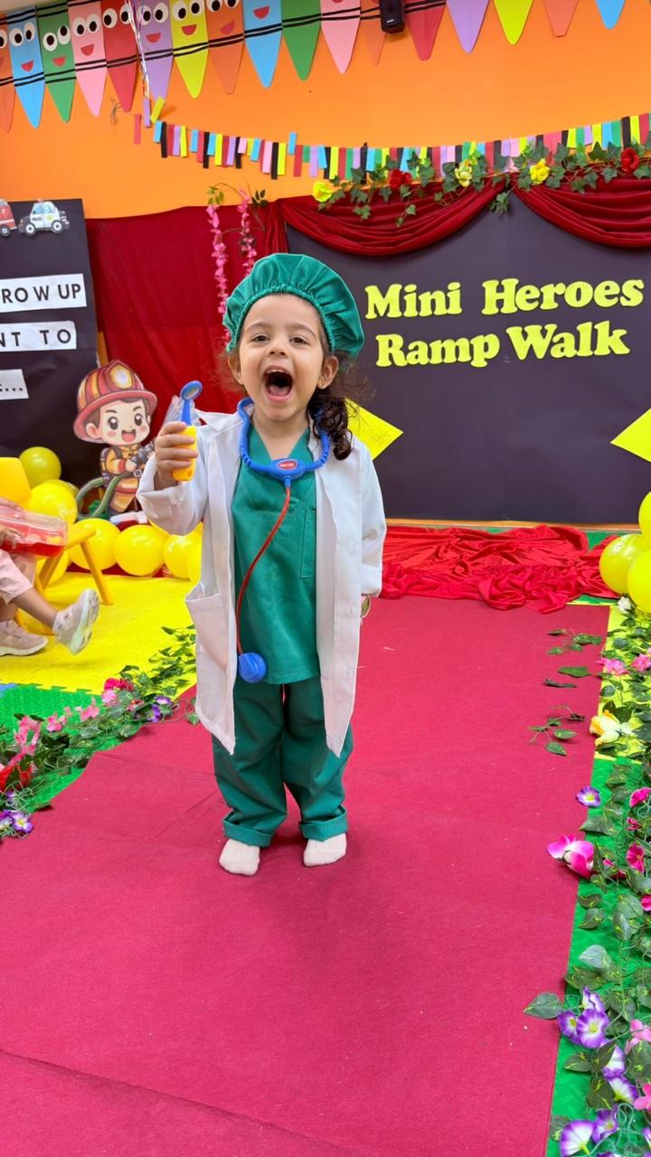 A little girl dressed as a doctor cheering on the Mini Heroes Ramp Walk stage